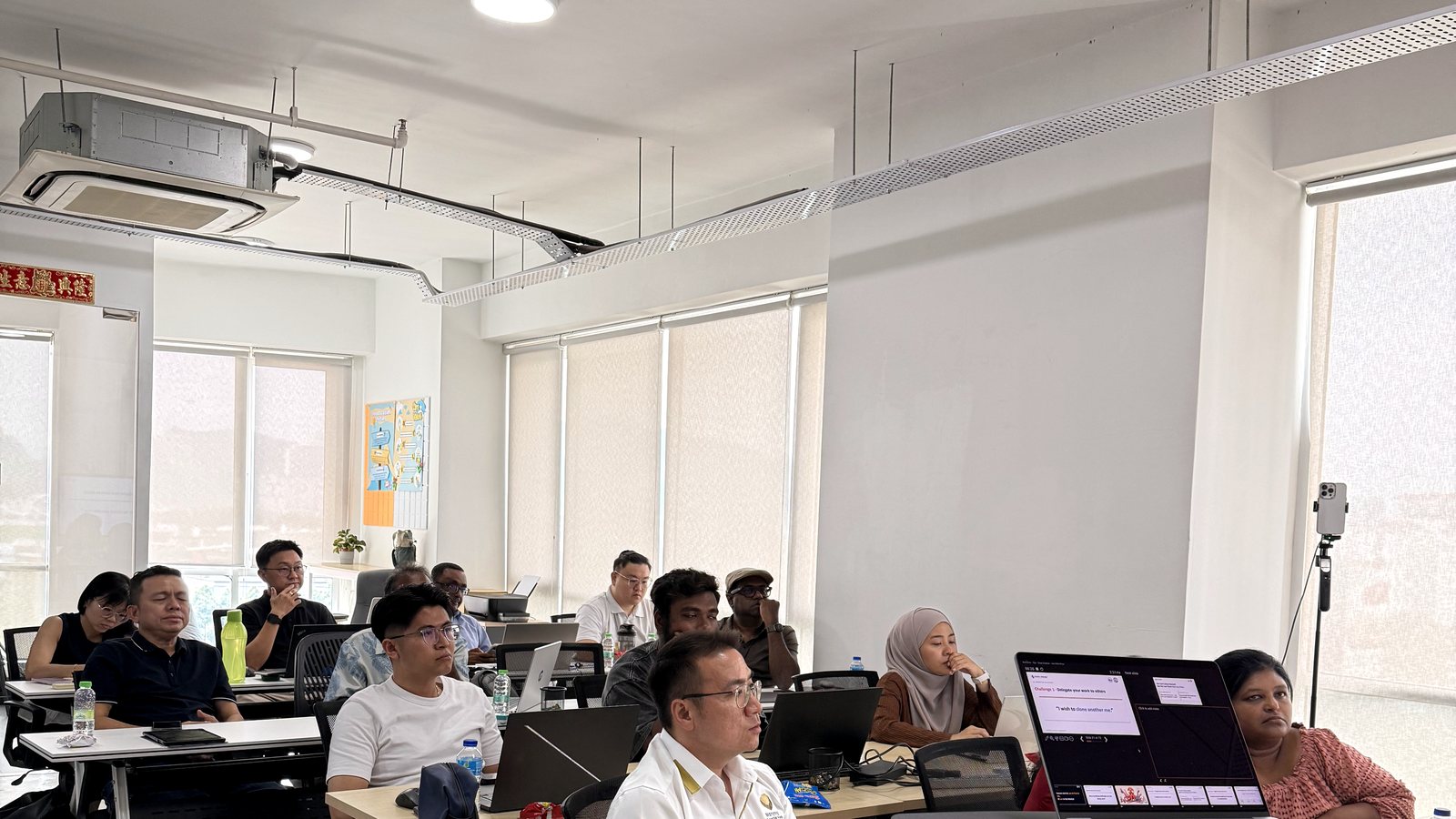 Participants working through a Stelix AI automation session in a daylit training room